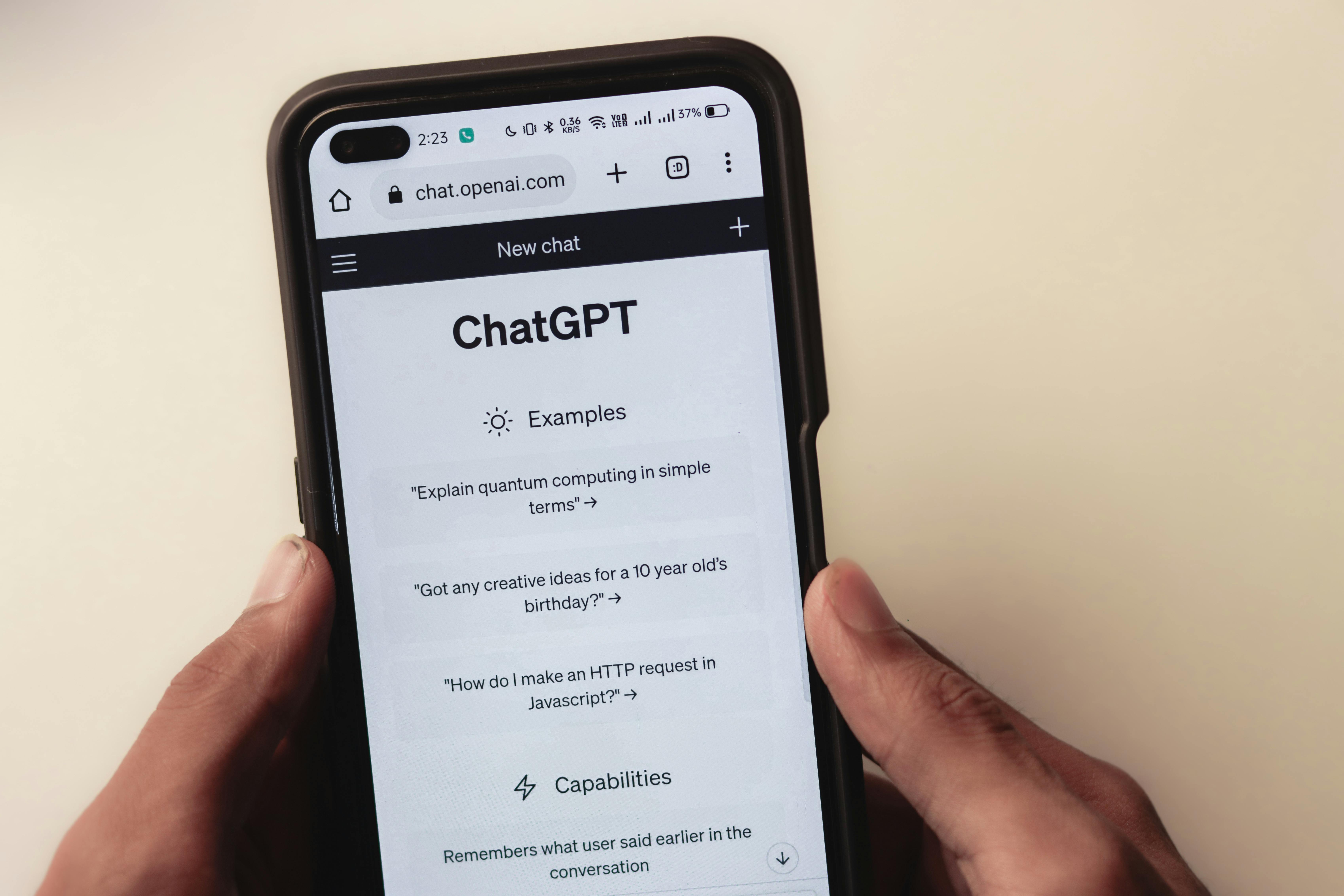 Image of a person holding a phone with ChatGPT on the screen