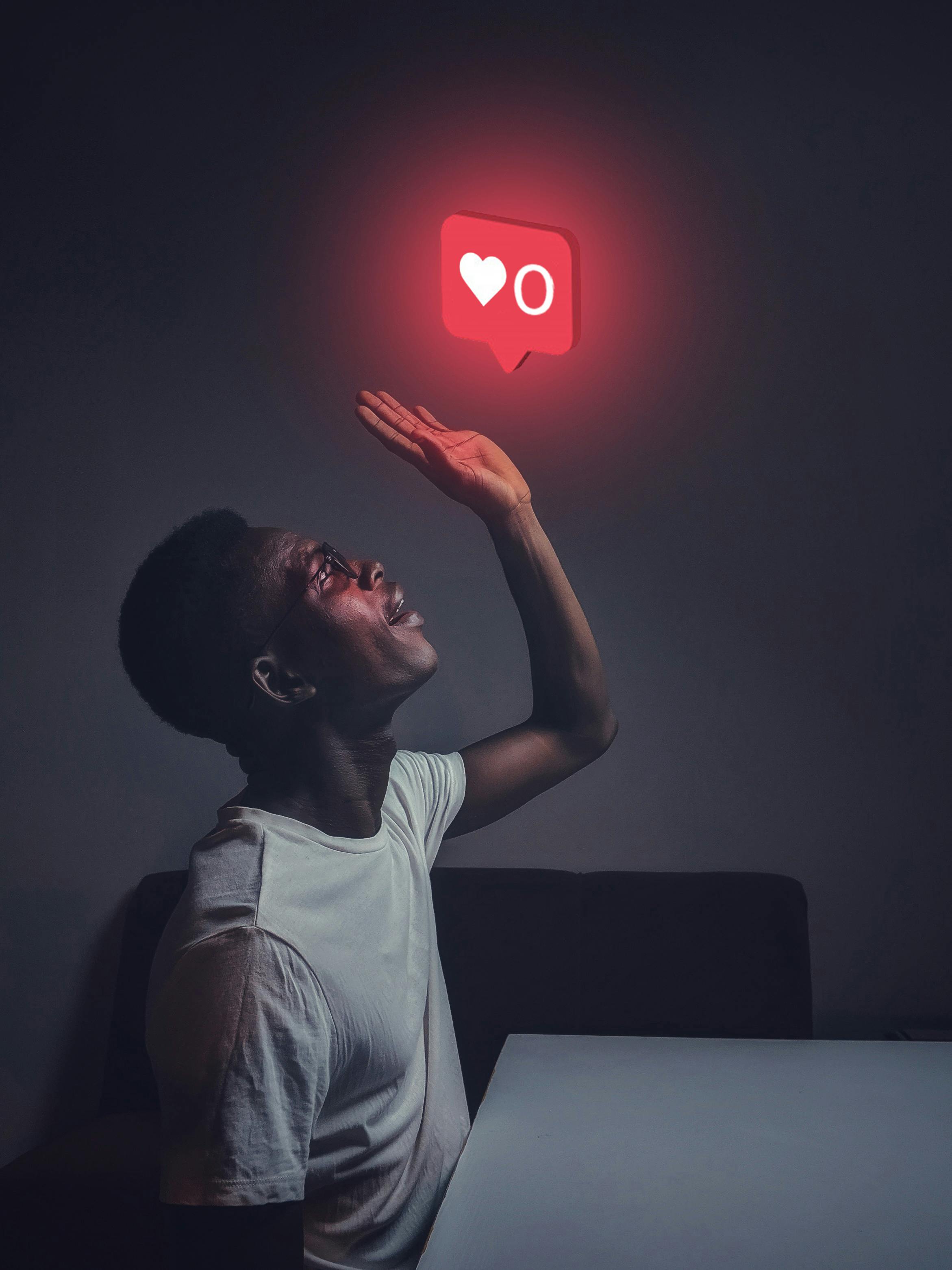 digitally altered image of a man holding his hand to a heart above his head like instagram likes